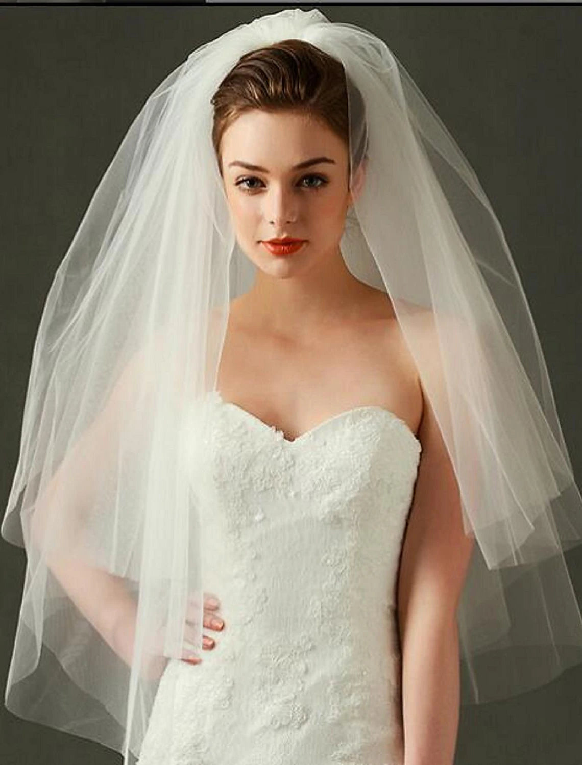Two-tier tulle wedding veil with delicate edge detail.