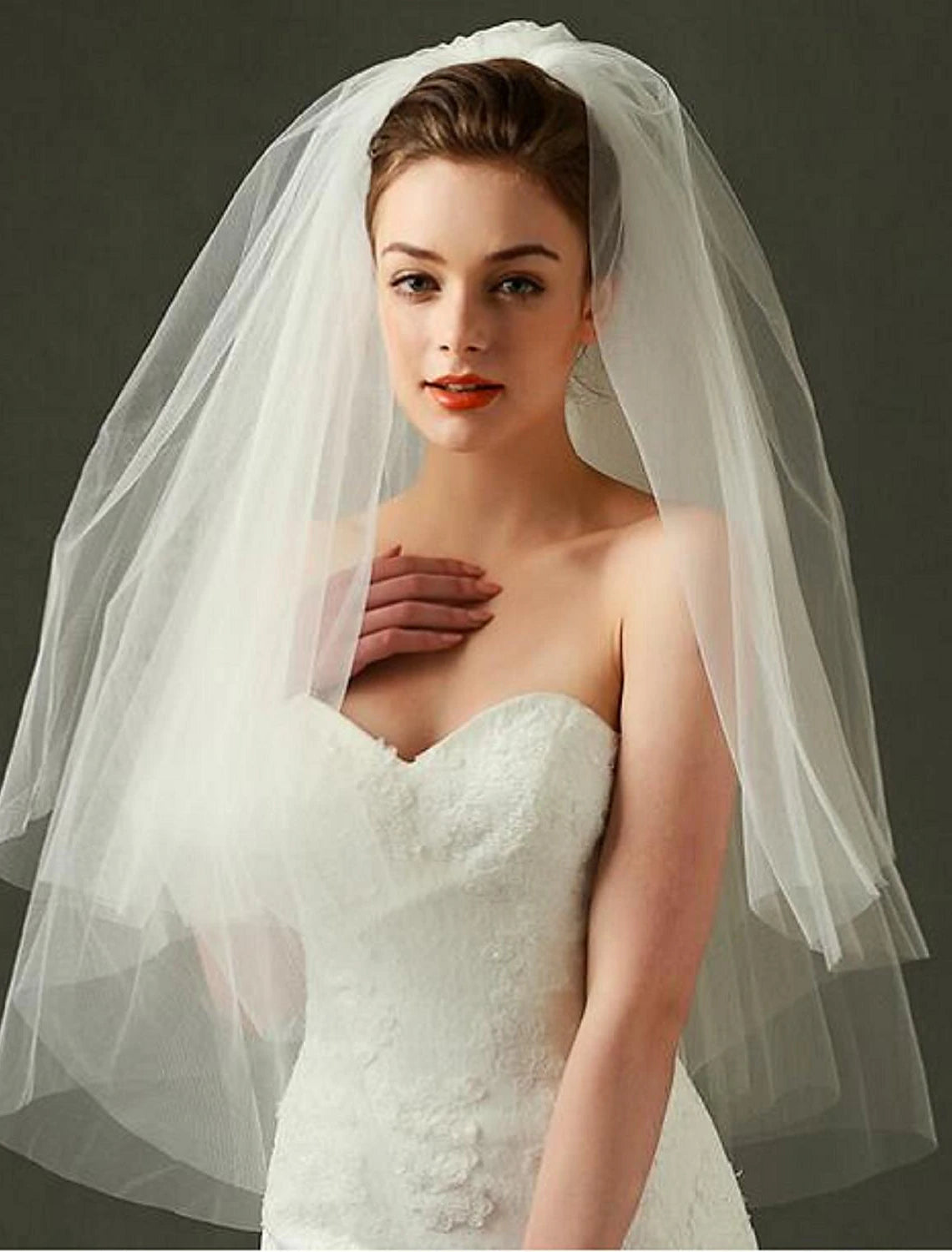 Elegant two-tier wedding veil, styled for a bridal look.