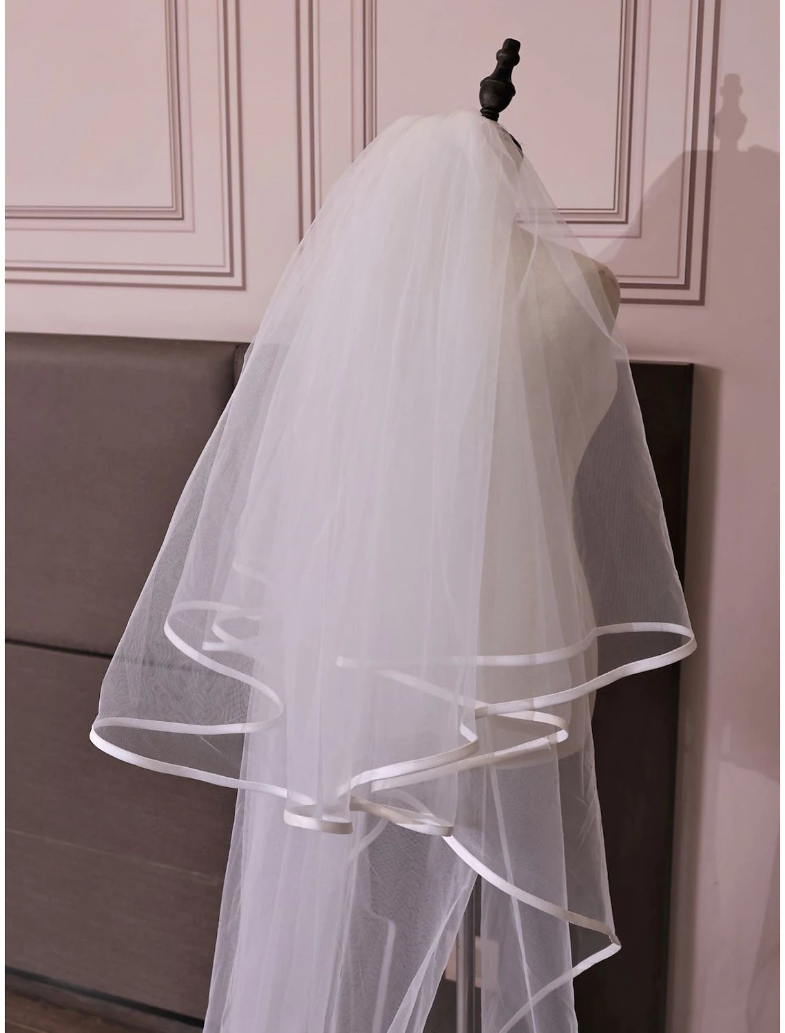 Sweet style wedding veil with two tiers, designed to flow elegantly behind the bride.