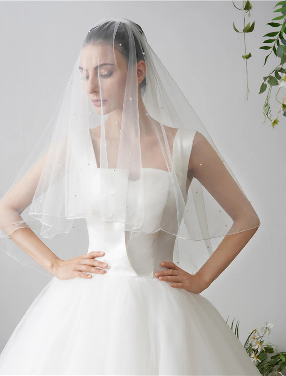 Graceful two-tier tulle wedding veil draped beautifully.