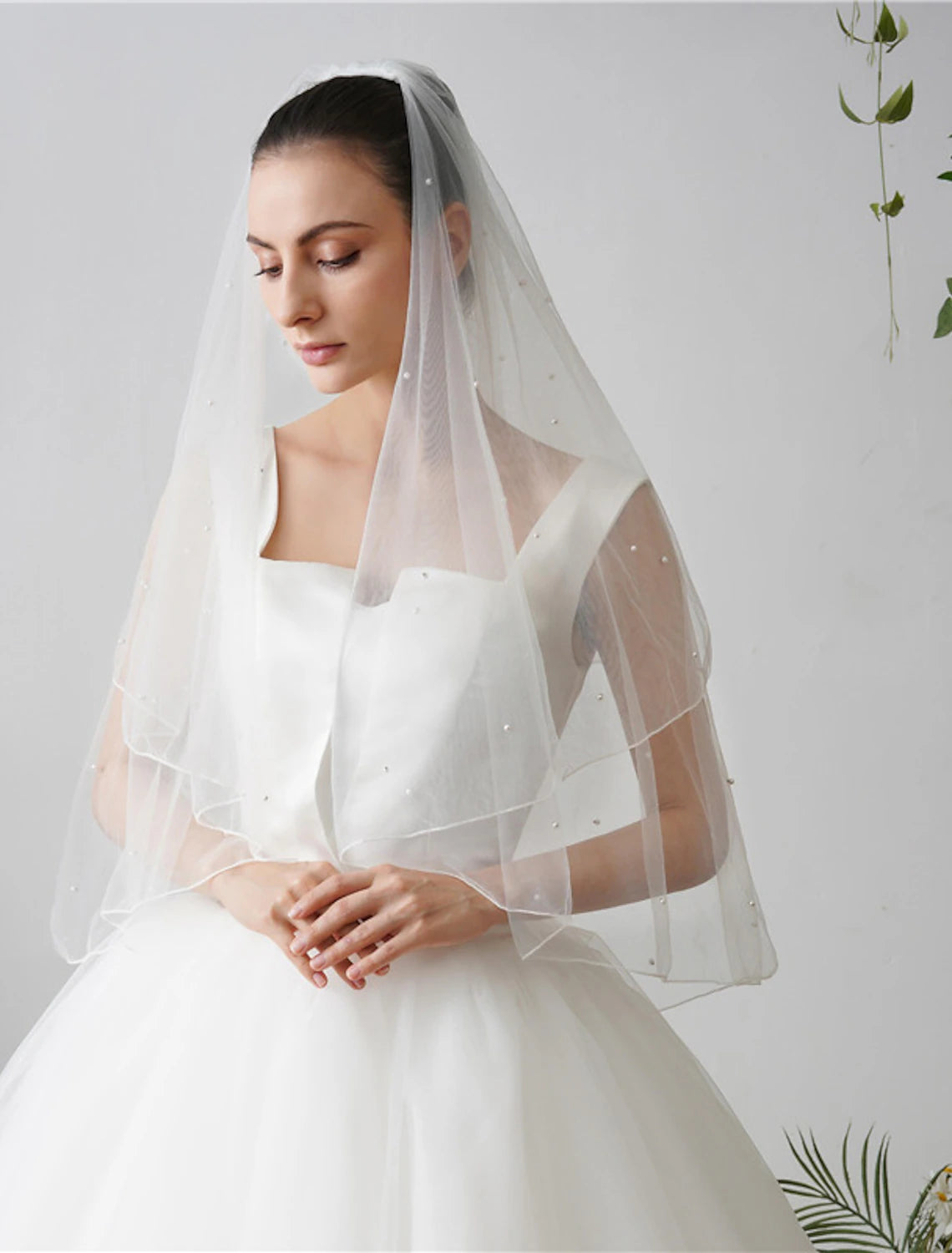 Close-up view of the faux pearls on the wedding veil.
