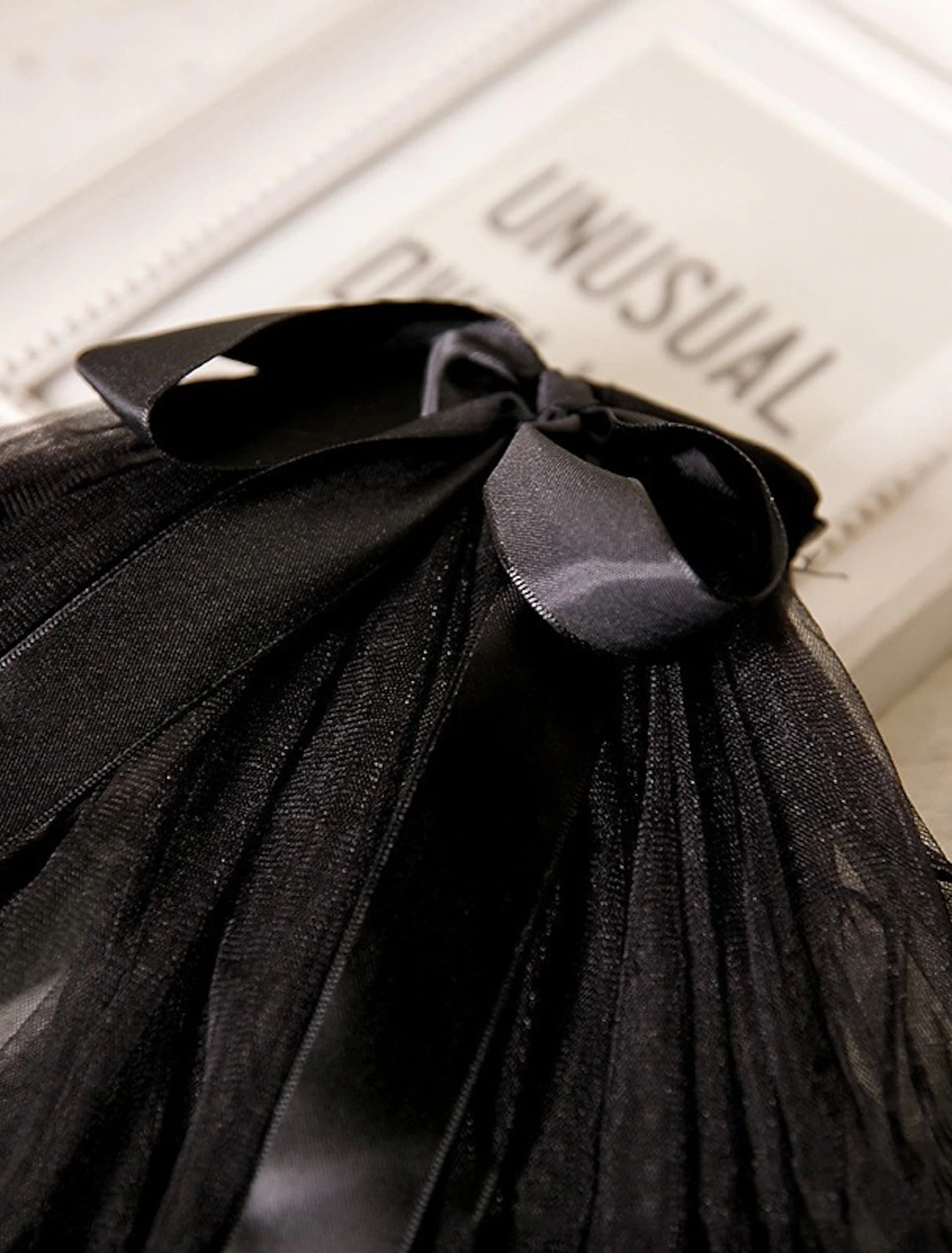 Back view of the two-tier pearl wedding veil with a satin bow.