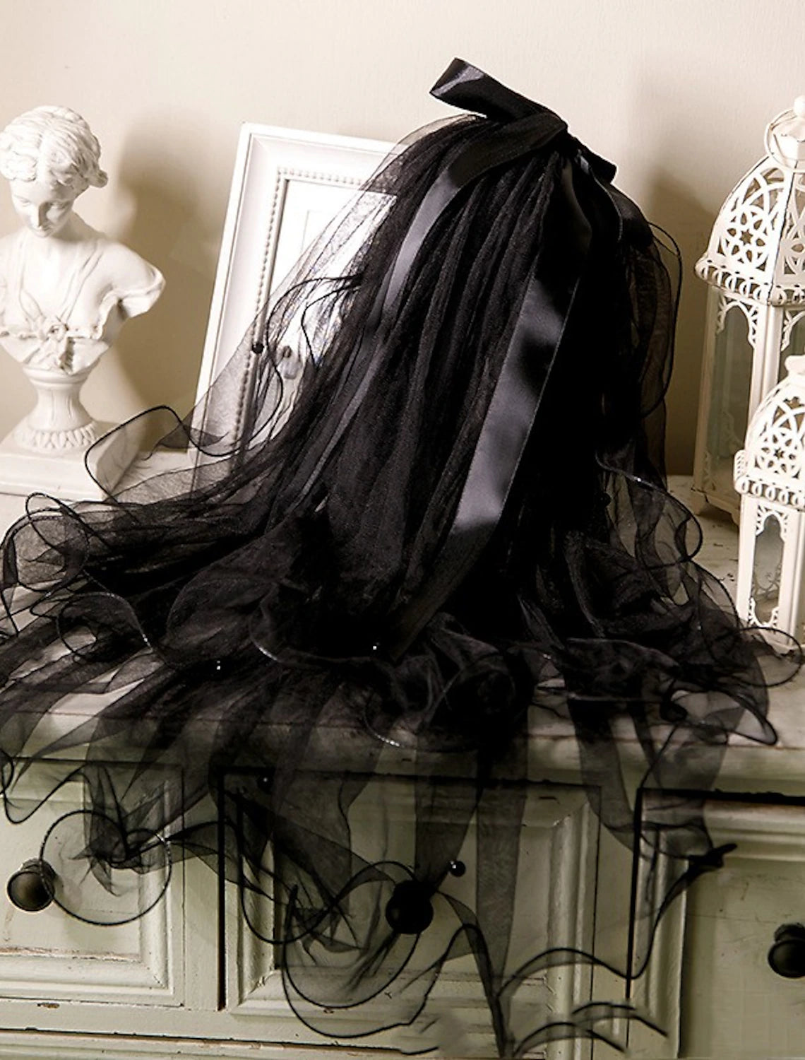 Detailed view of the delicate tulle fabric and pearl embellishments on the veil.