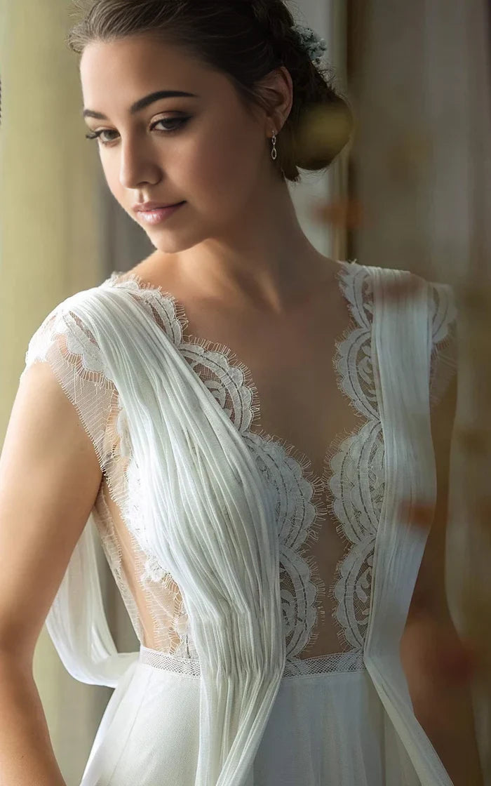 Side profile of an A-line V-neck chiffon lace wedding dress, highlighting pleats and lace details.
