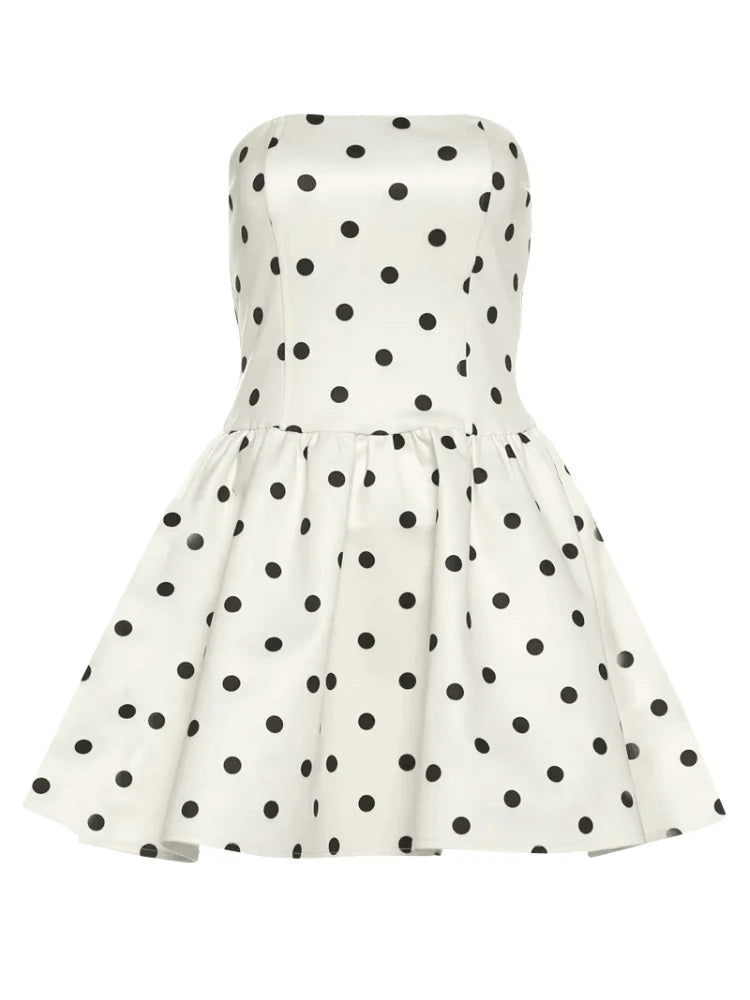 Model posing in the elegant V-neck polka dot mini dress, showcasing its movement.