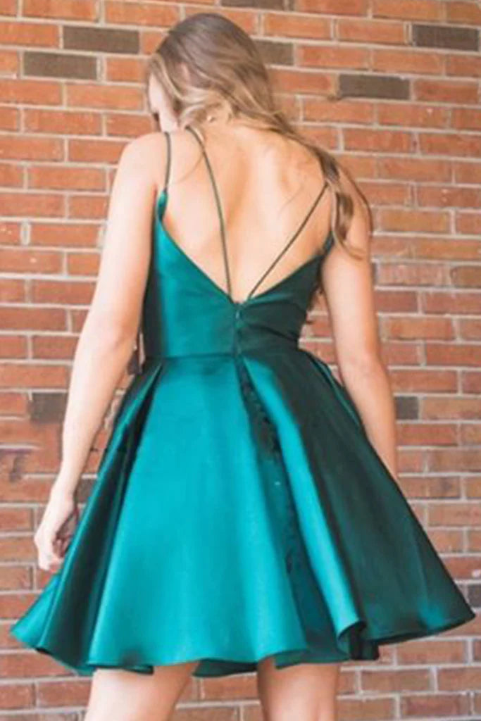 Woman posing in a flowy V-neck satin homecoming dress.