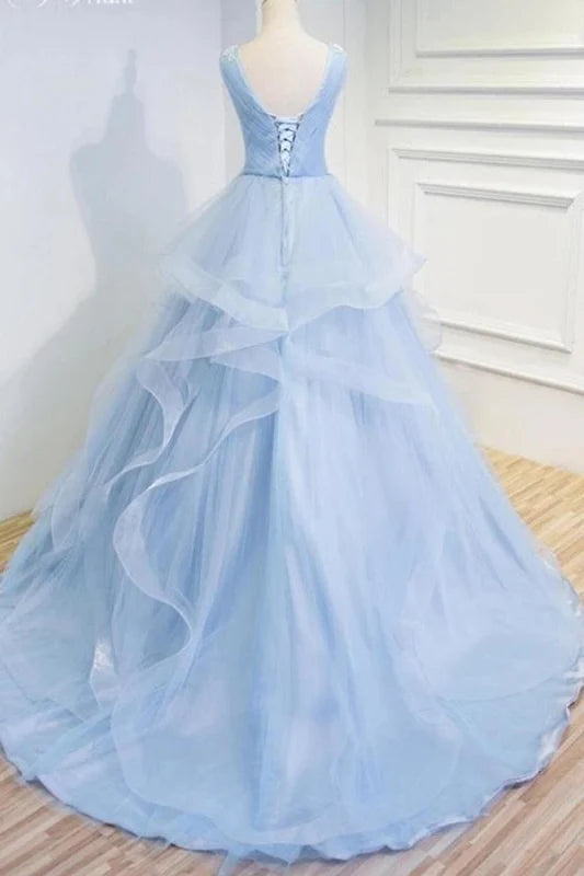 Close-up of the intricate appliques on the long sleeveless quinceanera dress.