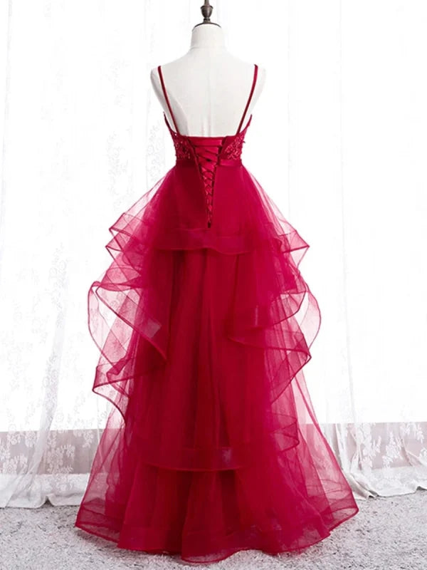 Side view of a woman wearing a V-neck backless lace formal gown.