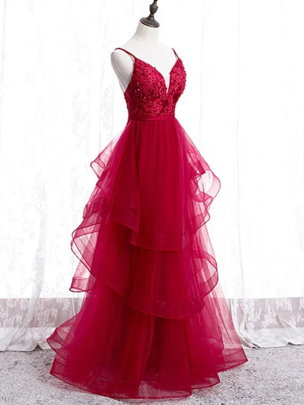 Close-up of intricate lace detail on a long prom dress.