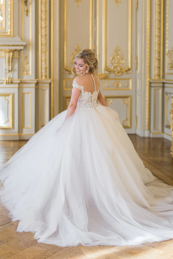 Close-up of delicate lace and tulle fabric on wedding dress bodice.