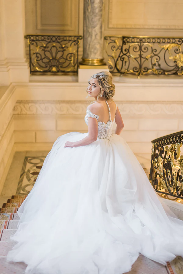 Back view of the flowing tulle skirt and train of the bridal gown.