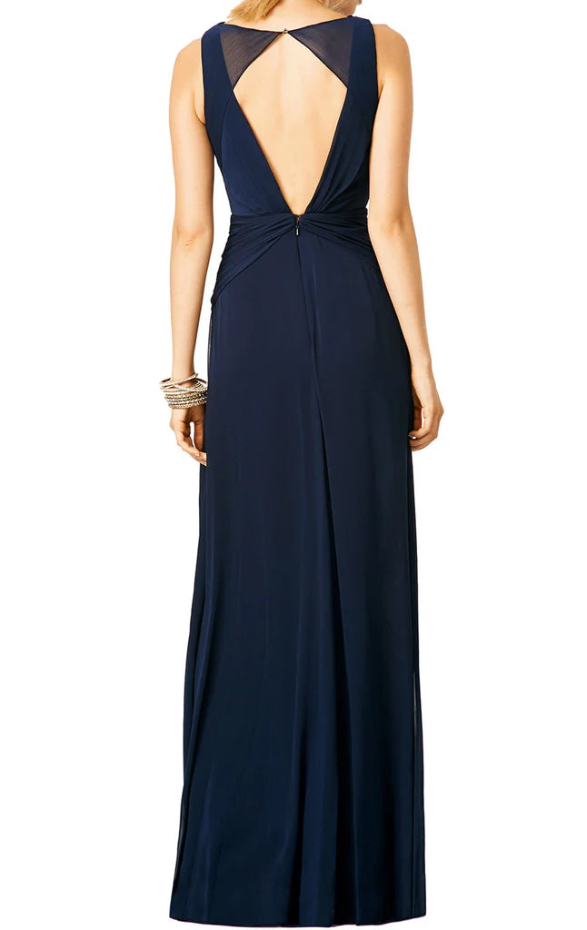 Back view of a V-neck chiffon formal gown showing open back detail.