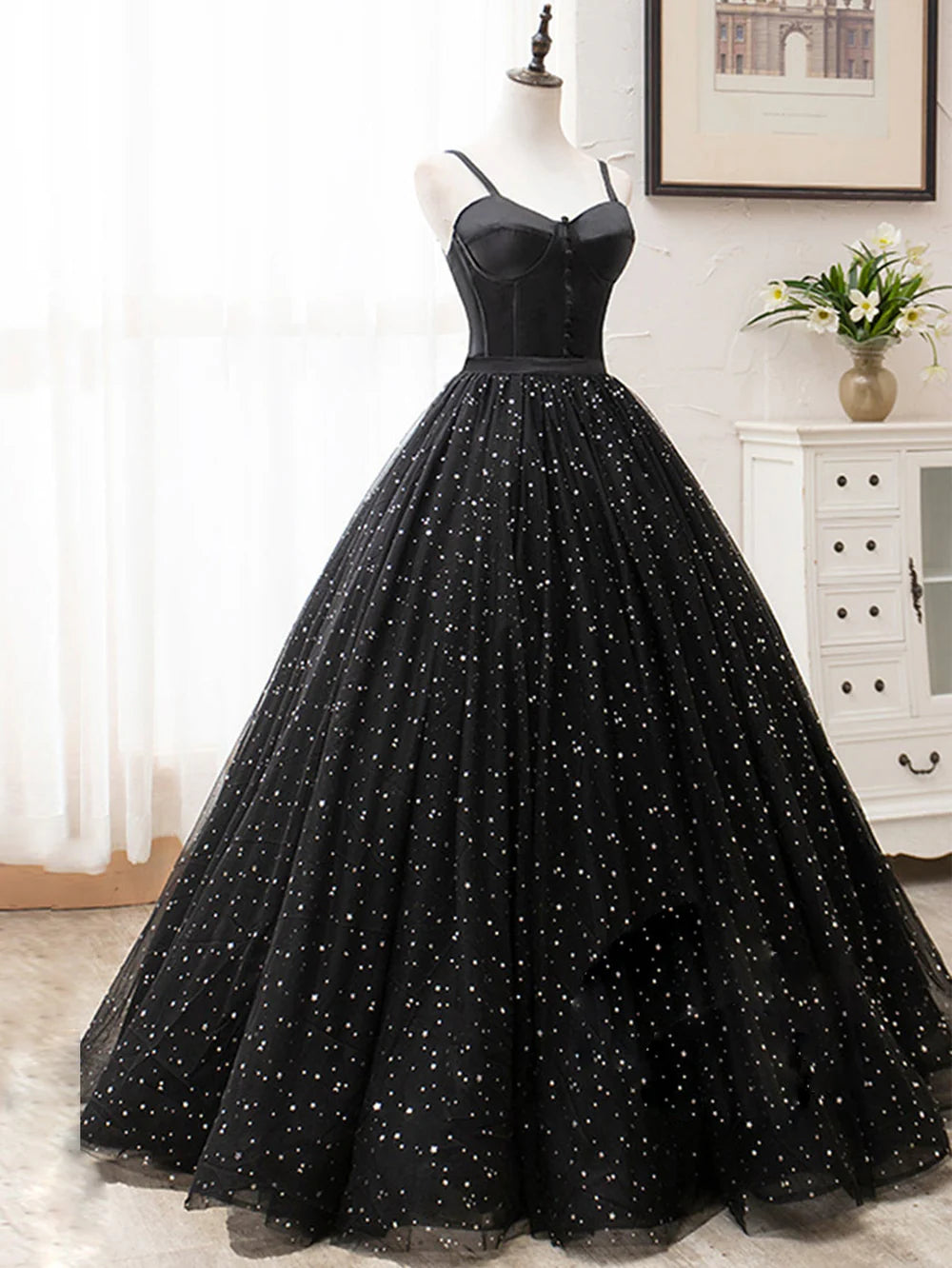 Close-up of the glitter fabric and V-neckline of the long prom dress.