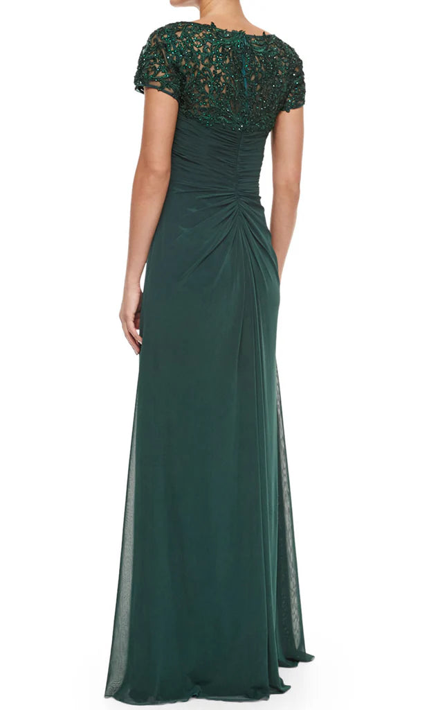 Back view of a woman in a long V-neck lace and chiffon Mother of the Bride dress with sleeves.