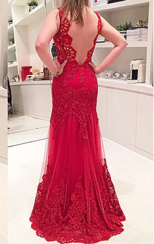 Back view of a woman in a long strappy formal gown with lace details.