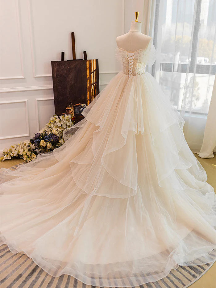 Back view of a long white lace tulle wedding gown.