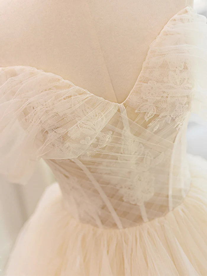 Side view of an A-line lace tulle wedding dress.