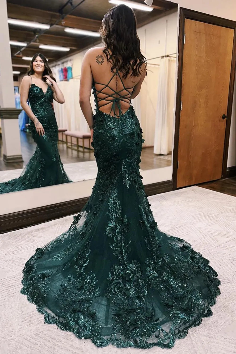 Back view of a prom gown with lace-up detailing.