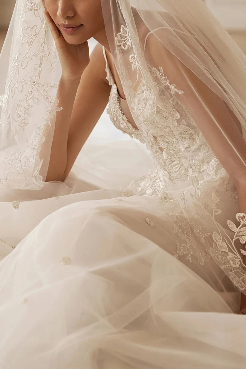 Full view of an elegant V-neck lace wedding dress with appliques.