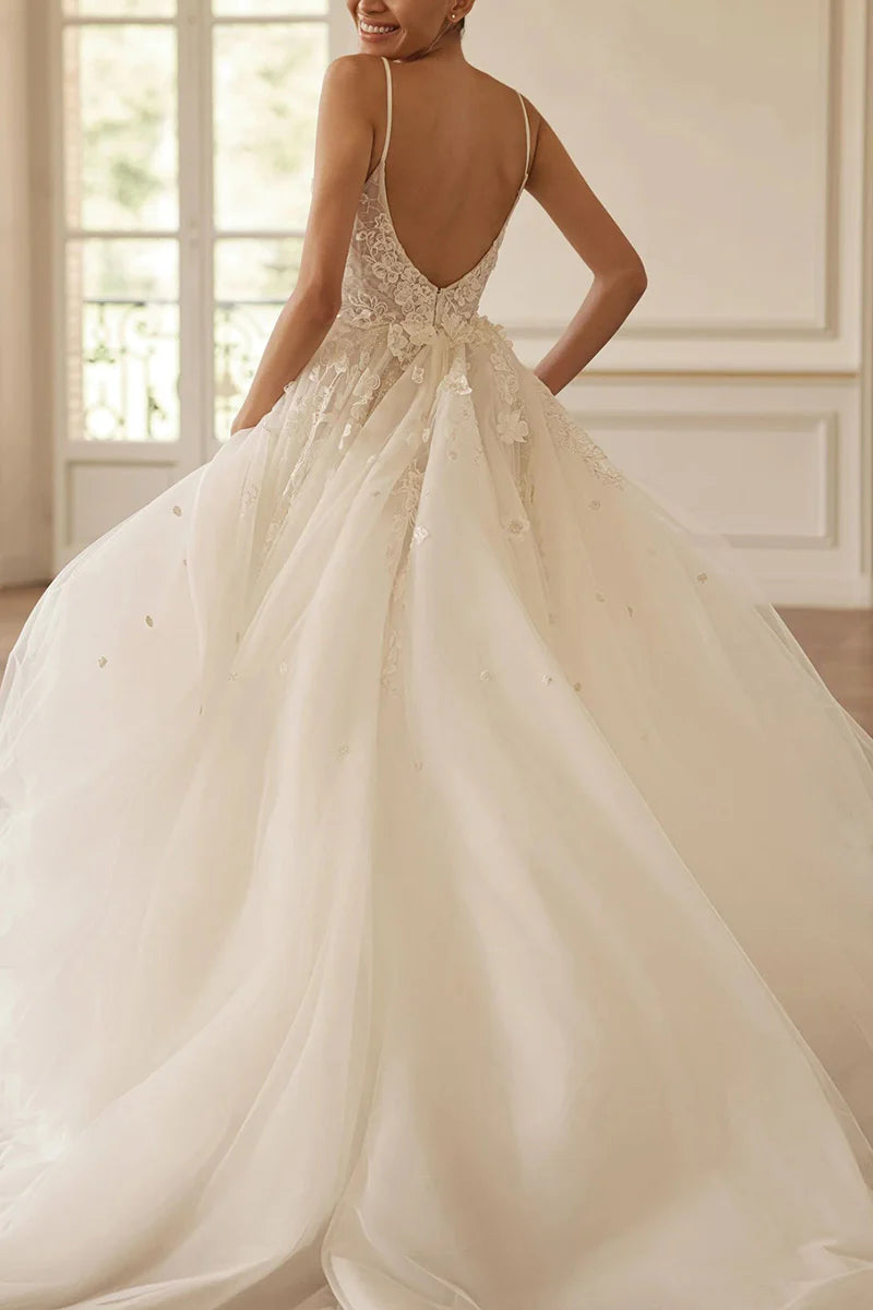 Side view of a romantic V-neck lace wedding gown.