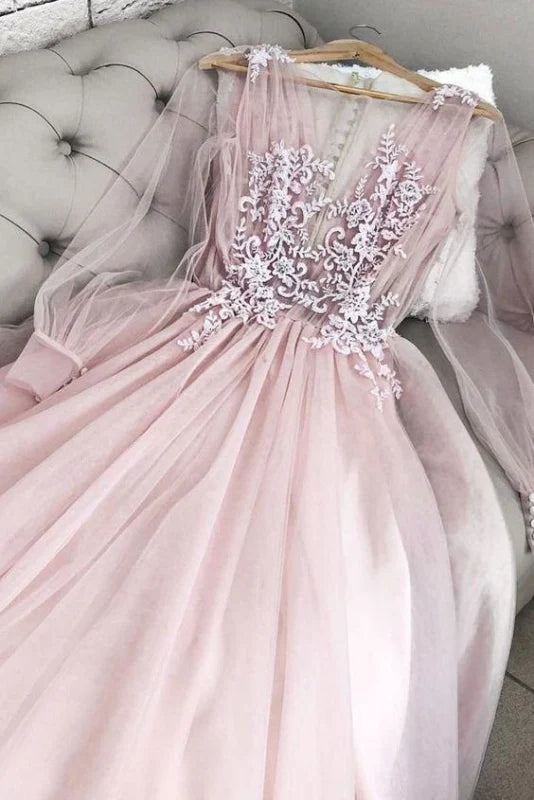 Elegant woman wearing a floor-length V-neck prom gown with long sheer sleeves and delicate lace appliques.