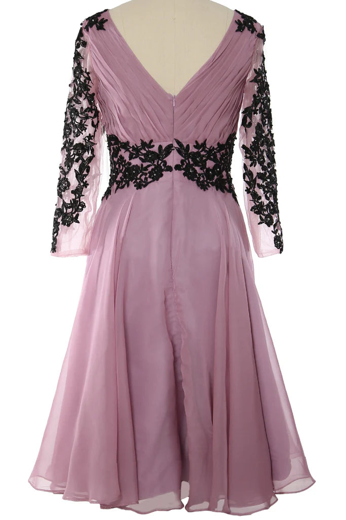 Back view of a woman wearing a long sleeve formal dress.