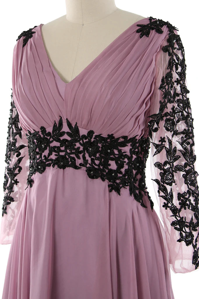 Side profile of a woman in a V-neck formal gown.