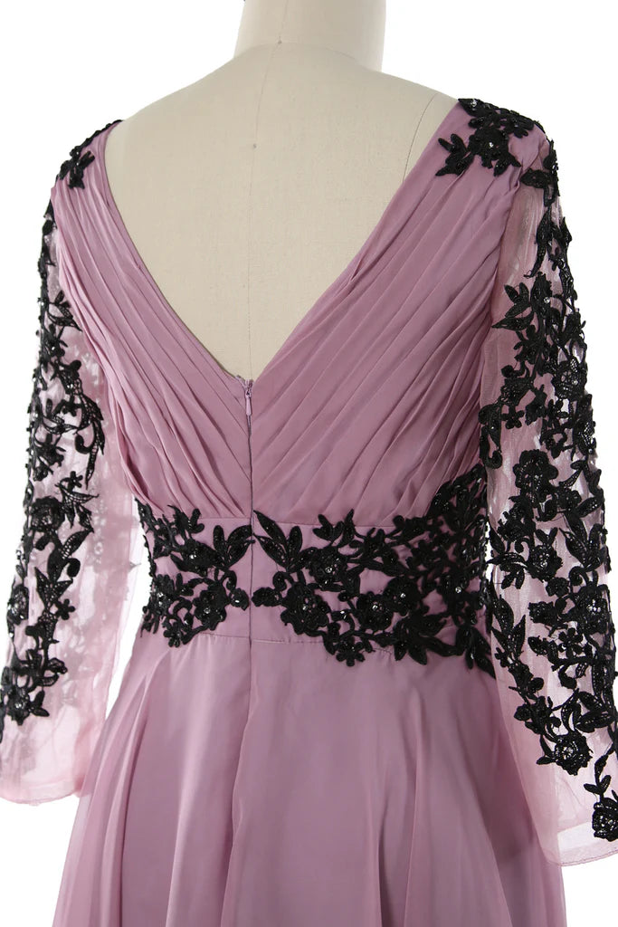Close-up of the V-neck and long sleeves of the formal dress.