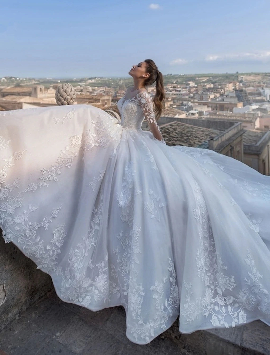 Close-up detail of the delicate lace appliques on the long sleeve ball gown wedding dress.