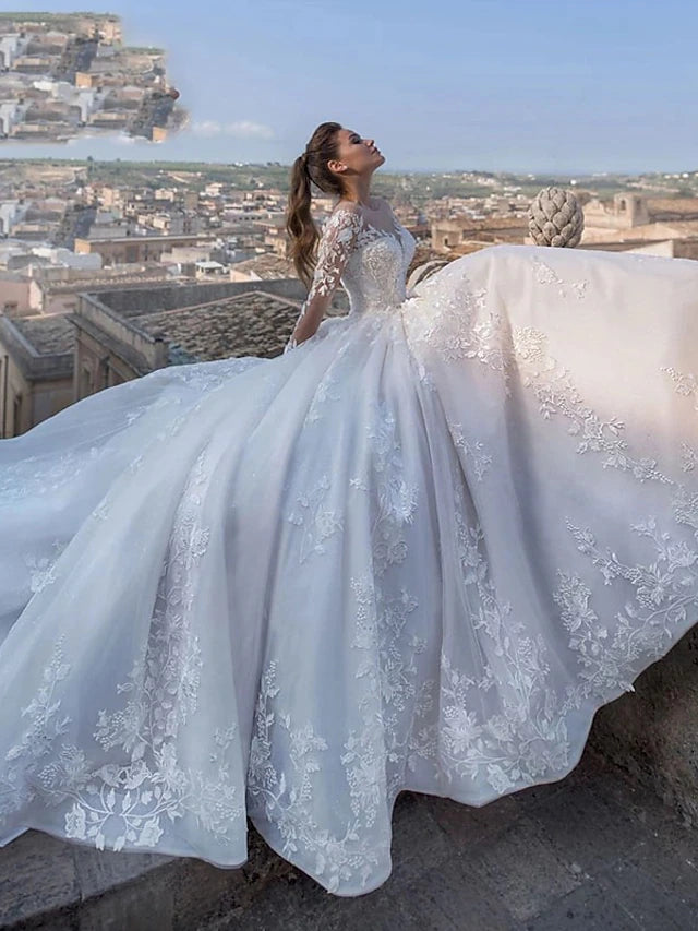 Close-up of V-neck lace bodice and long sleeves on wedding dress.