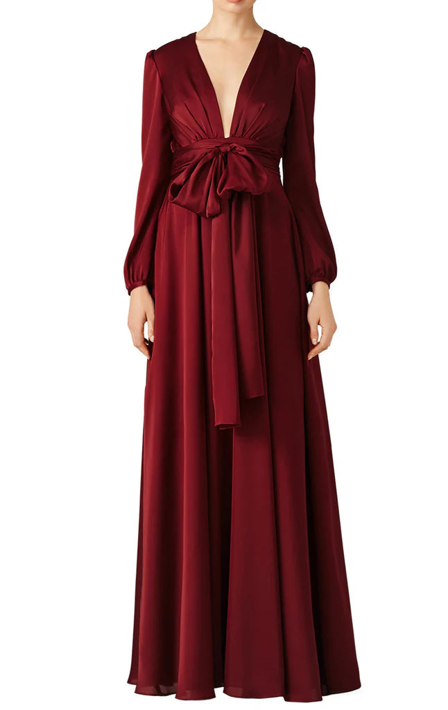 A woman wearing an elegant V-neck long sleeve mother of the bride dress.