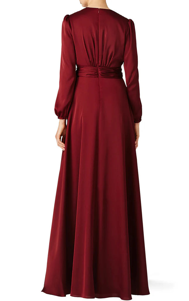 A woman modeling a formal V-neck long sleeve dress for special occasions.