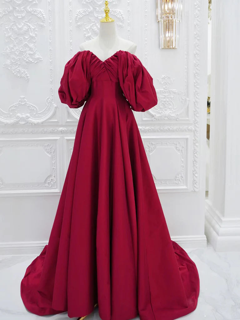 Full length view of a woman wearing an elegant V-neck long sleeve satin formal dress.
