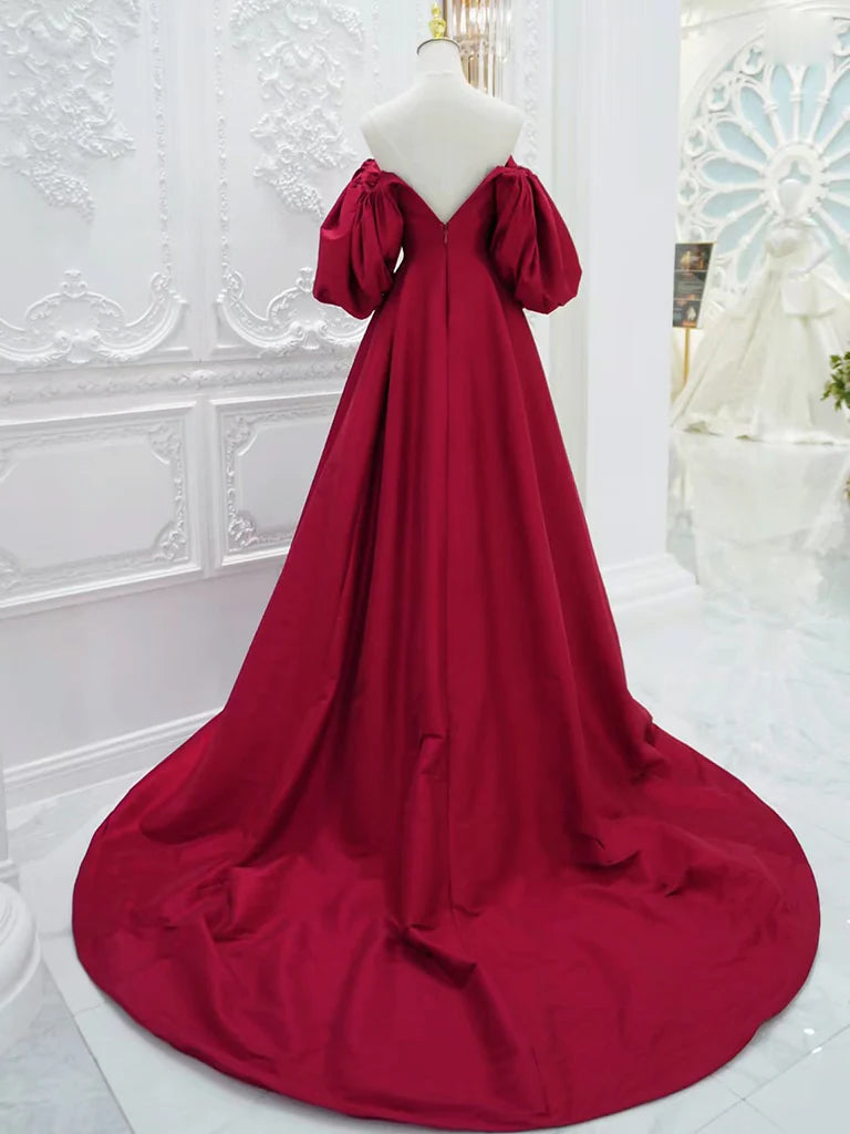 Side view of a woman in a V-neck long sleeve satin gown, showcasing the elegant silhouette.