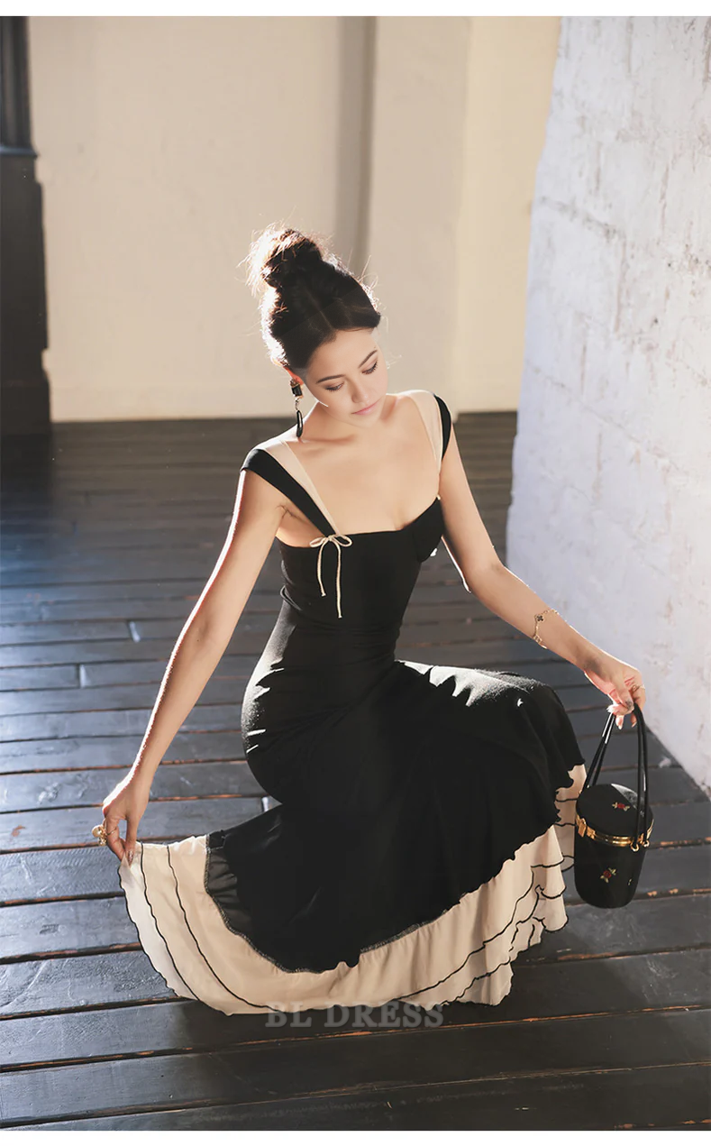Side view of a model wearing the black mermaid prom dress.