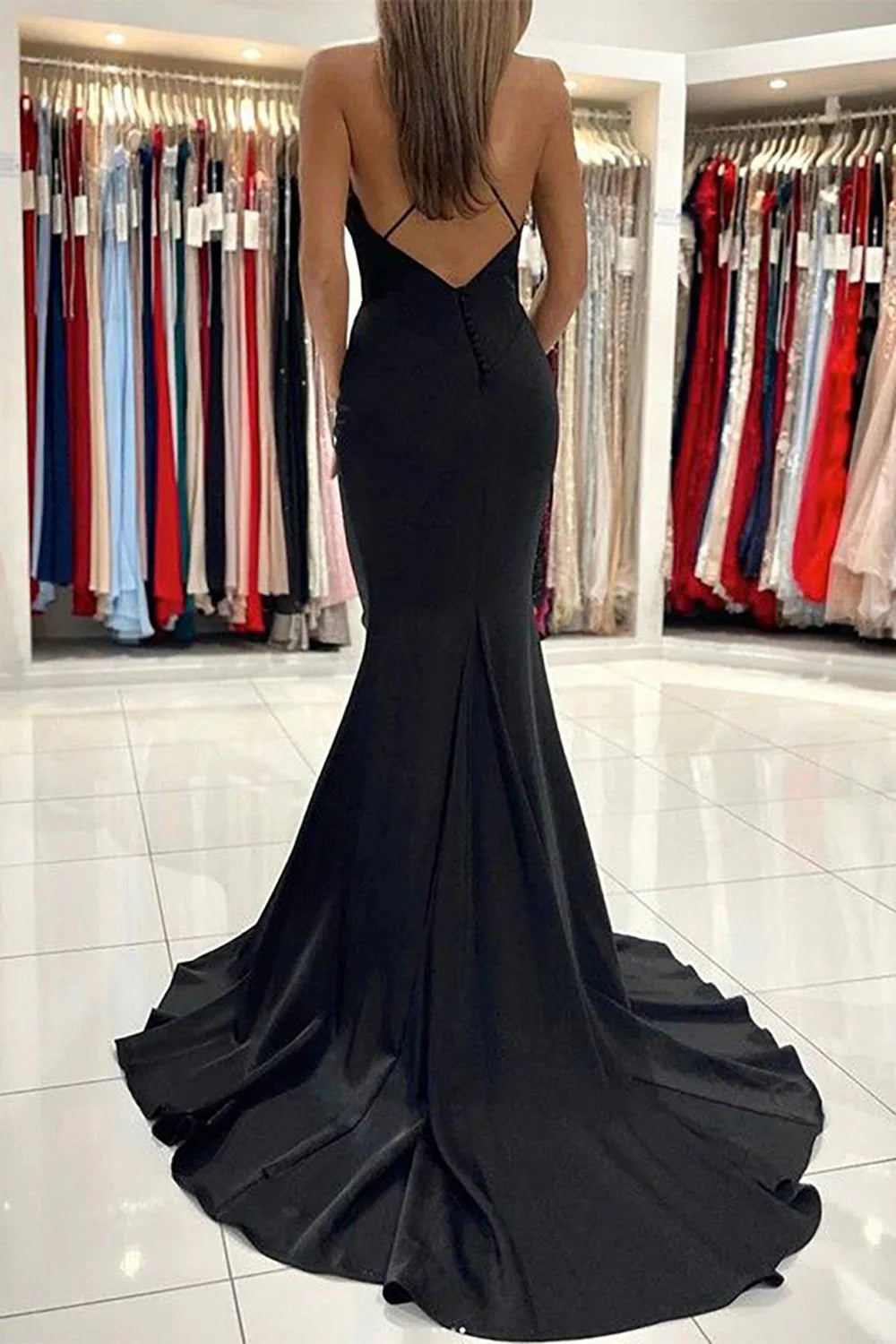Full view of the mermaid spaghetti strap formal gown.