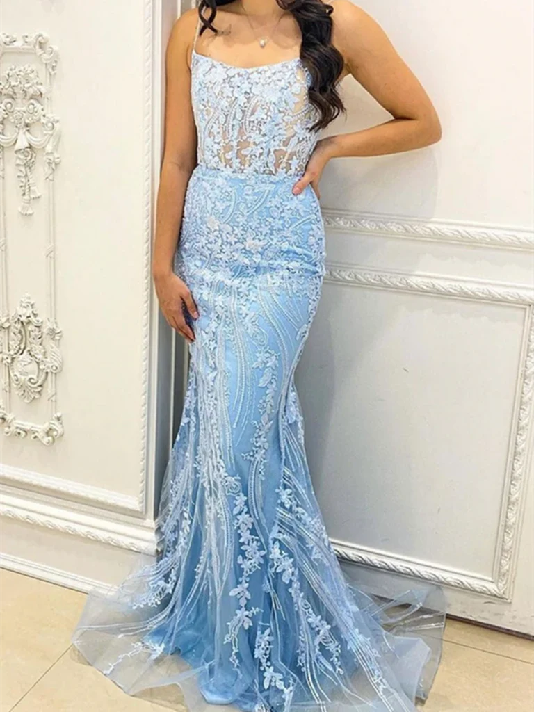 Woman wearing an elegant V-neck mermaid prom dress with delicate lace and flowing tulle details.