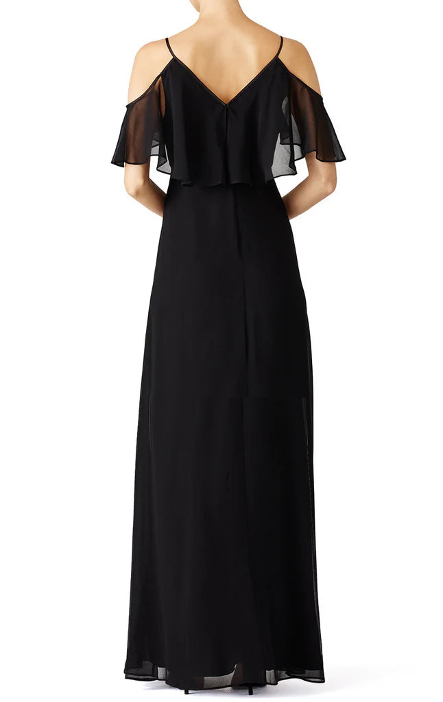 Back view of a woman in a flowing chiffon formal gown.
