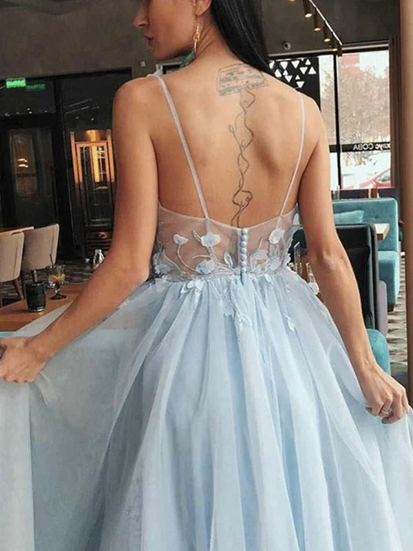 Side view of a woman wearing a floral long prom gown.