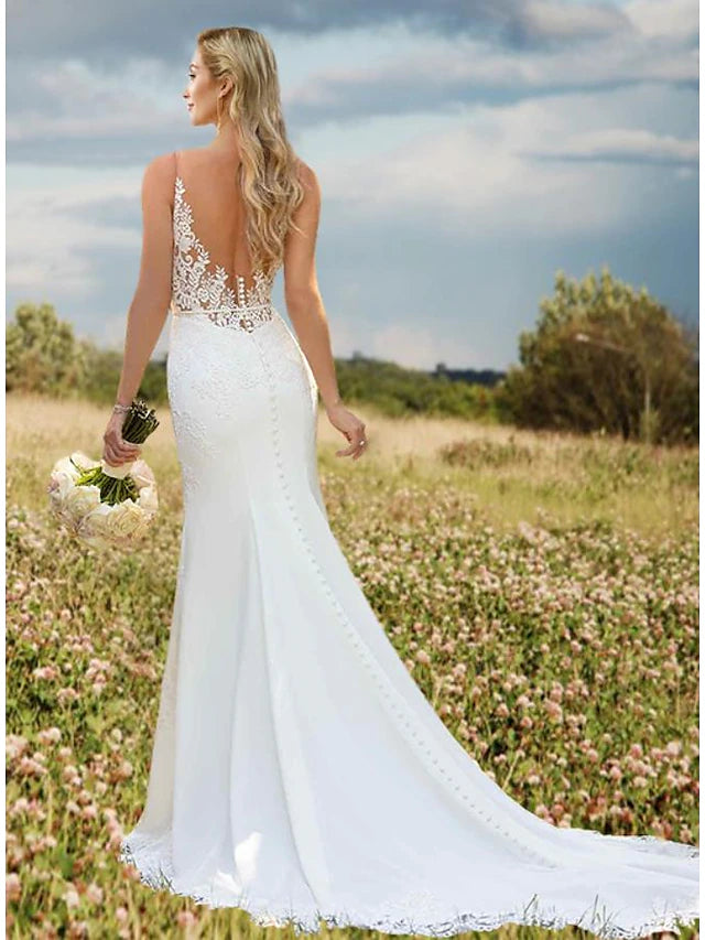 Back view of the mermaid trumpet wedding dress showcasing the open back and court train.