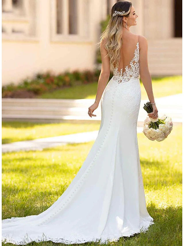 Close-up of delicate appliques on the crepe fabric of the wedding dress.