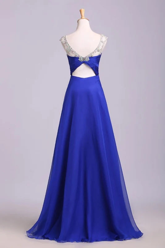 Close-up of the pleated skirt and belted waist of the chiffon prom dress.