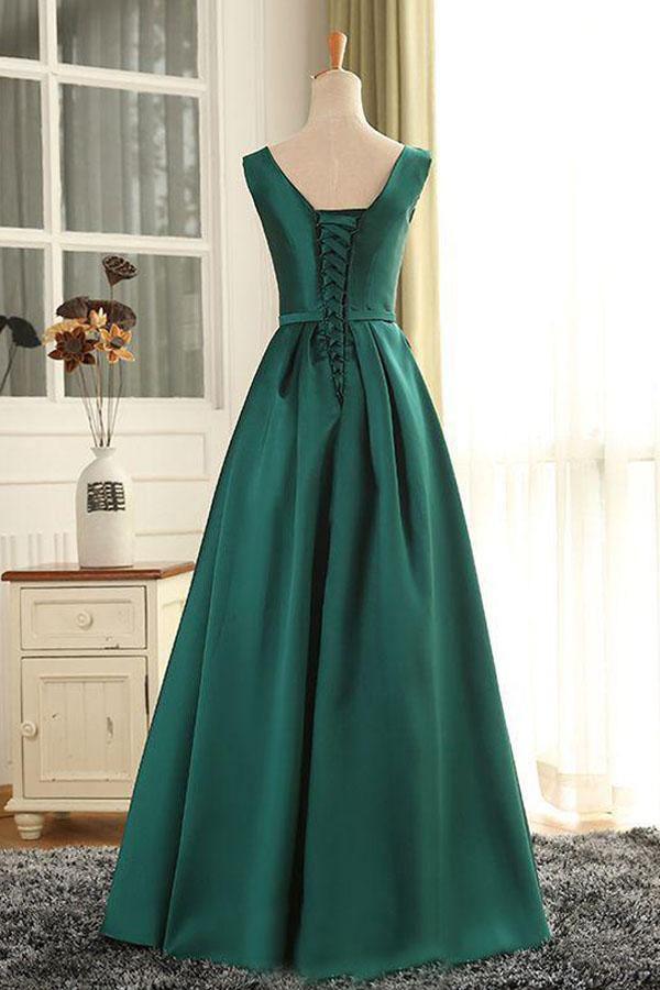 Side view of a woman in a flowing satin formal gown.