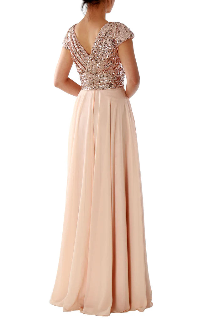 Side view of a woman in a short sleeve V-neck sequin chiffon formal dress.