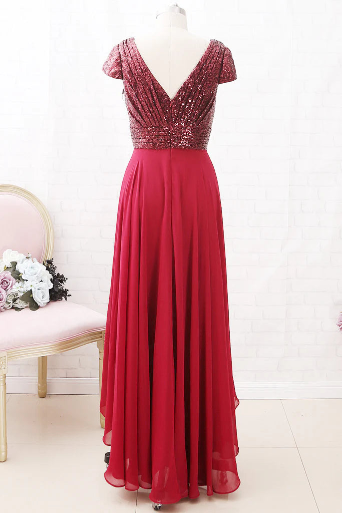 Side view of a woman in a sleeveless V-neck sequin chiffon high-low dress, showcasing the flowing skirt.