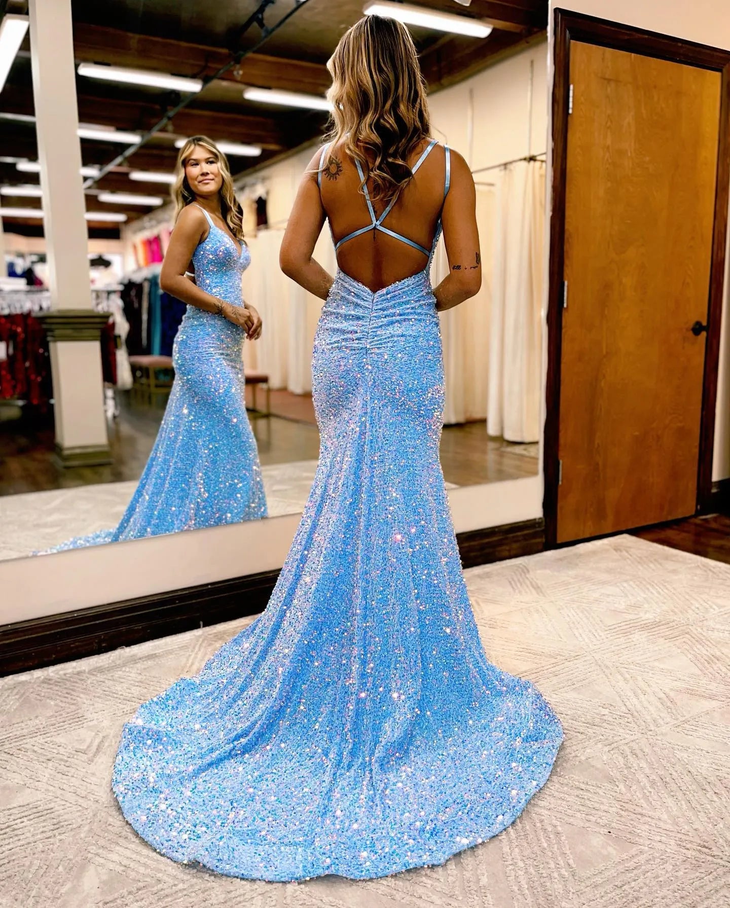 Back view of a sequined mermaid prom dress with court train.