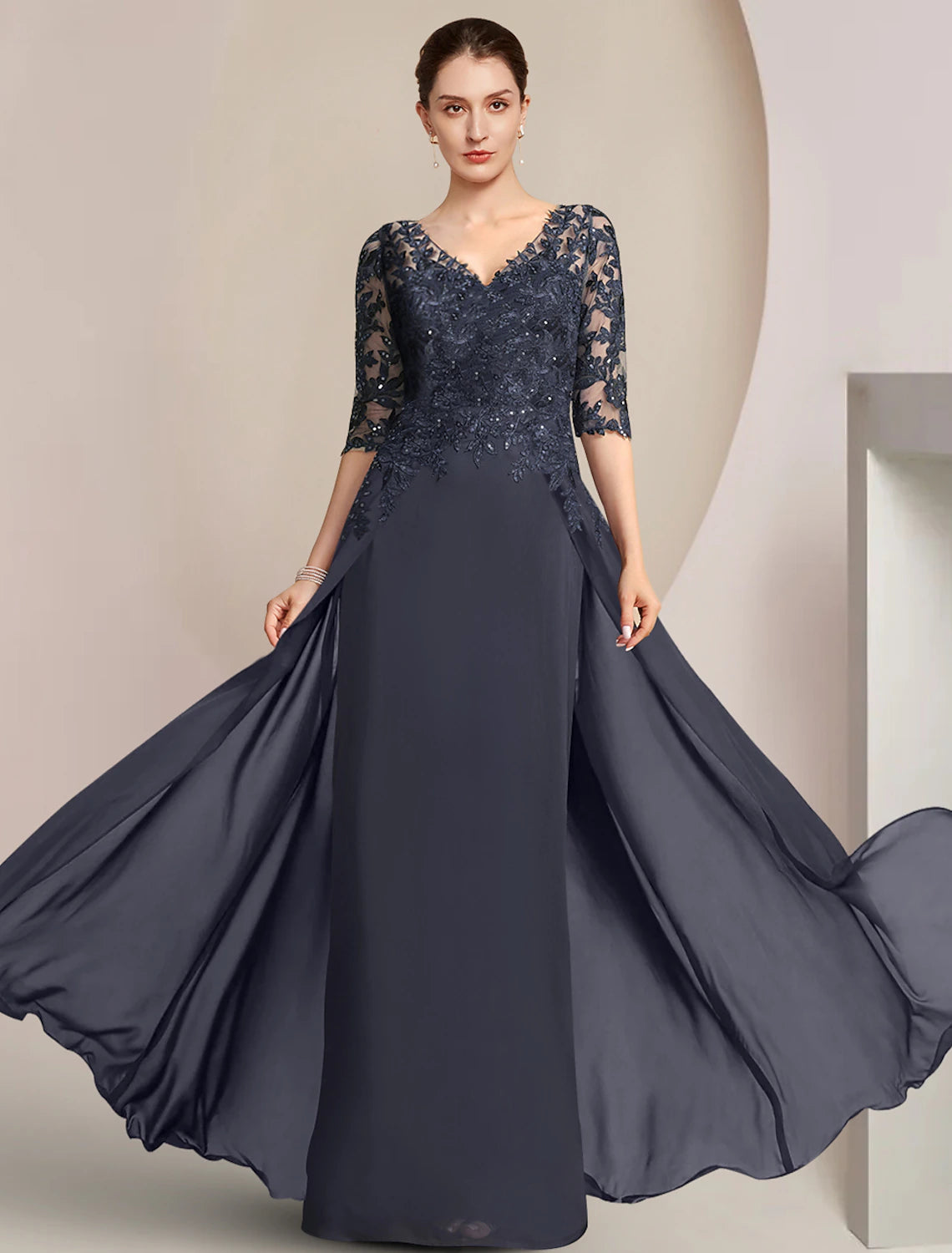 Elegant V-neck sheath dress with half sleeves and sequin appliques.