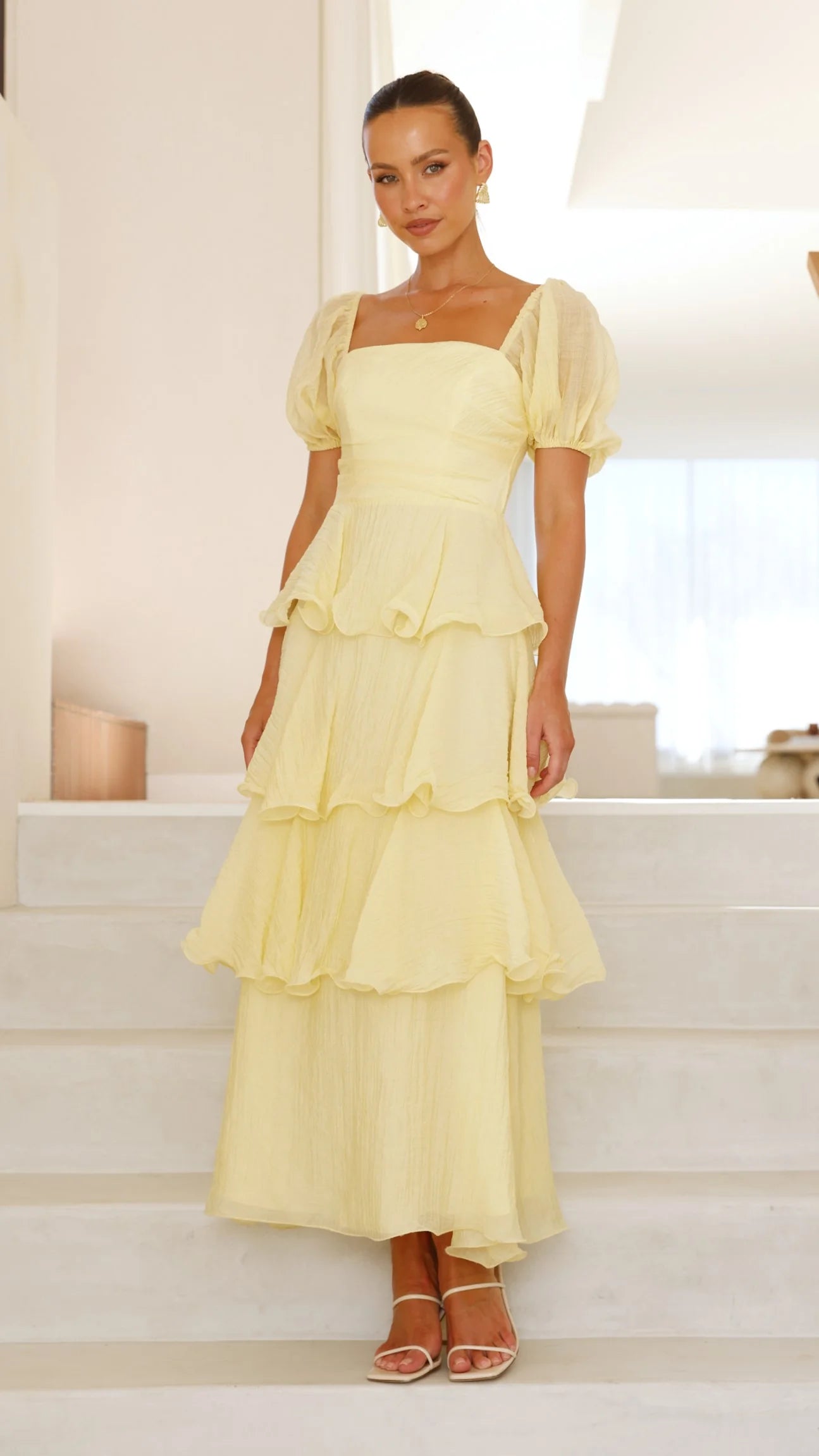Woman posing in a flowing A-line maxi dress.