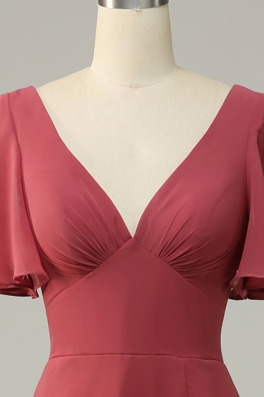 Side profile of a woman in a desert rose V-neck short sleeve formal dress.