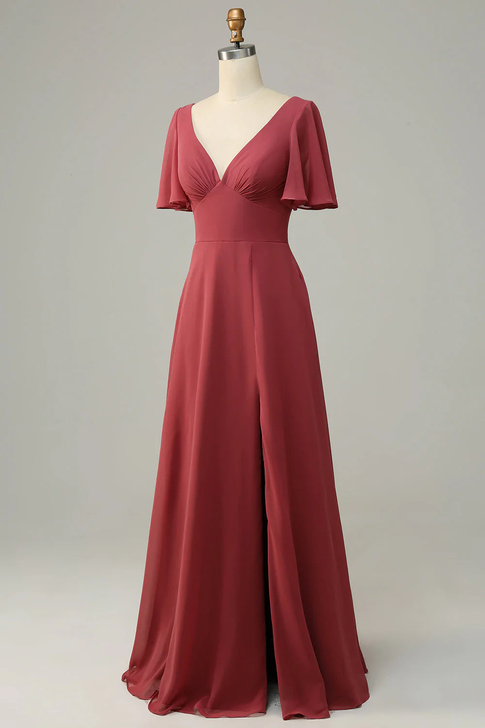 Full length view of a woman posing in a desert rose V-neck short sleeve bridesmaid dress.